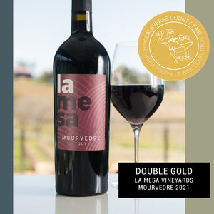 Bottle and glass of La Mesa Vineyards Mourvedre 2021 wine with a gold award label.