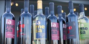 Multiple bottles of La Mesa wine with various labels displayed.